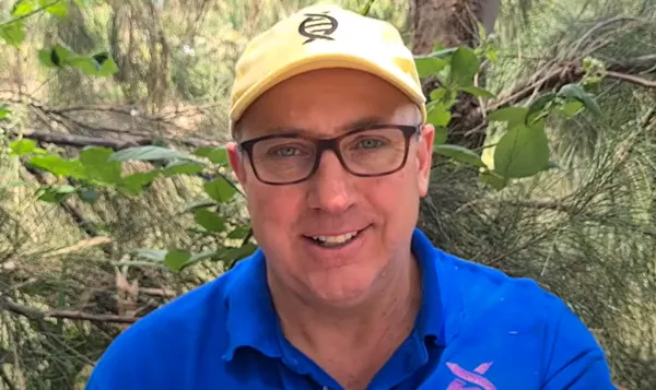 Duncan Farquhar, founder of ecoconnect, smiling outdoors in a cap